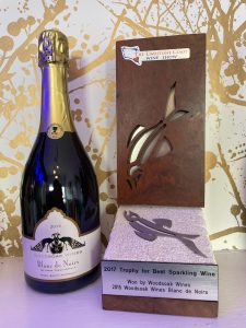 Bottle of 2015 Blanc de Noirs next to a limestone coast wine awards trophy.