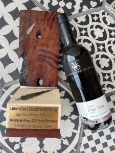 A bottle of Pyaar Pinot Noir next to a trophy for Best French Heritage Single Red at the 2024 Limestone Coast Wine Show